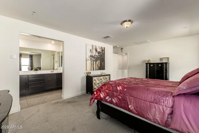 an aerial view of a city with lots of residential buildings ocean and mountain view in back