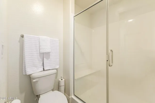 a view of a patio with table and chairs potted plants and a large tree