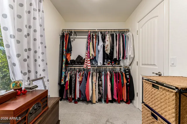 a view of a white house with a big yard and large tree
