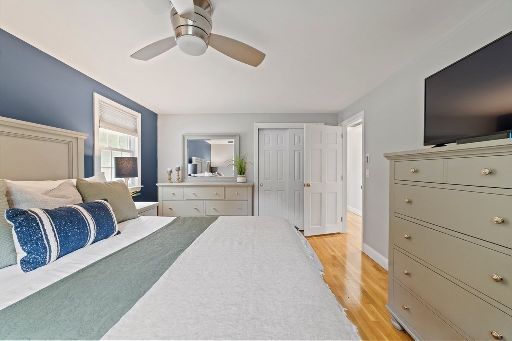 56 Cedarcrest Road Hanover, MA 02339 - Photo 11 of 26 a bedroom with a large bed and a flat tv screen on dresser