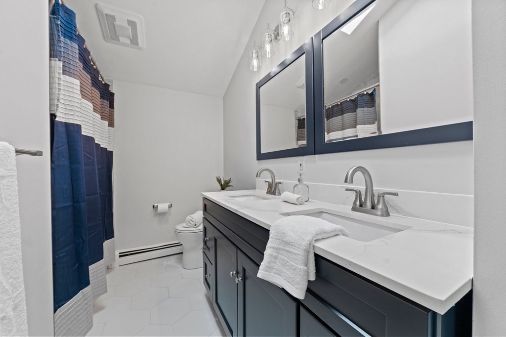 56 Cedarcrest Road Hanover, MA 02339 - Photo 14 of 26 a bathroom with a granite countertop sink a toilet and a mirror