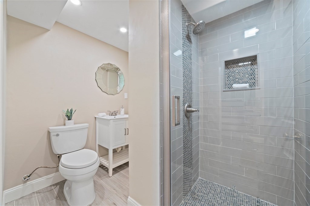56 Cedarcrest Road Hanover, MA 02339 - Photo 18 of 26 a bathroom with a toilet a sink and a shower