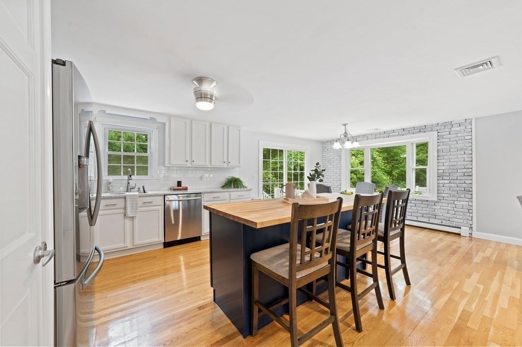 56 Cedarcrest Road Hanover, MA 02339 - Photo 4 of 26 a kitchen with a table chairs stove and refrigerator