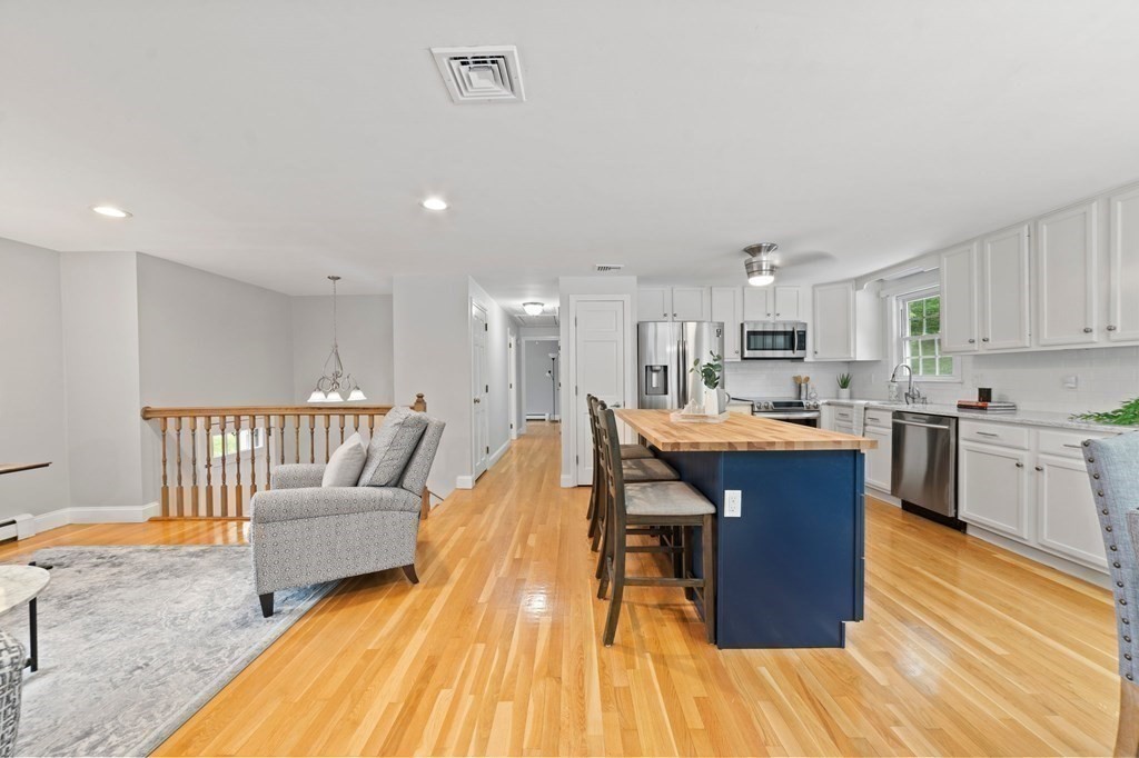 56 Cedarcrest Road Hanover, MA 02339 - Photo 7 of 26 a living room with stainless steel appliances kitchen island granite countertop furniture wooden floor and a kitchen view