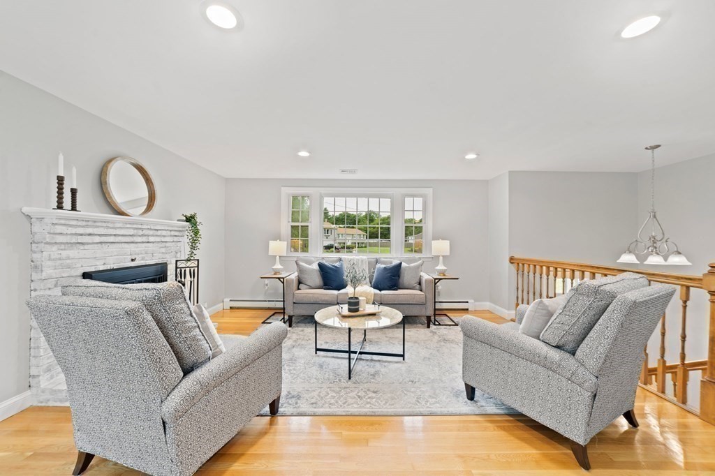 56 Cedarcrest Road Hanover, MA 02339 - Photo 9 of 26 a living room with furniture a fireplace and a large window