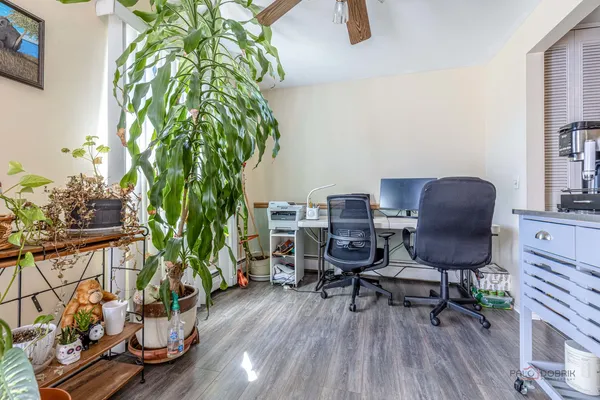 a view of a workspace with furniture and a potted plant