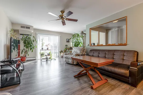 a living room with furniture gym equipment and a large window