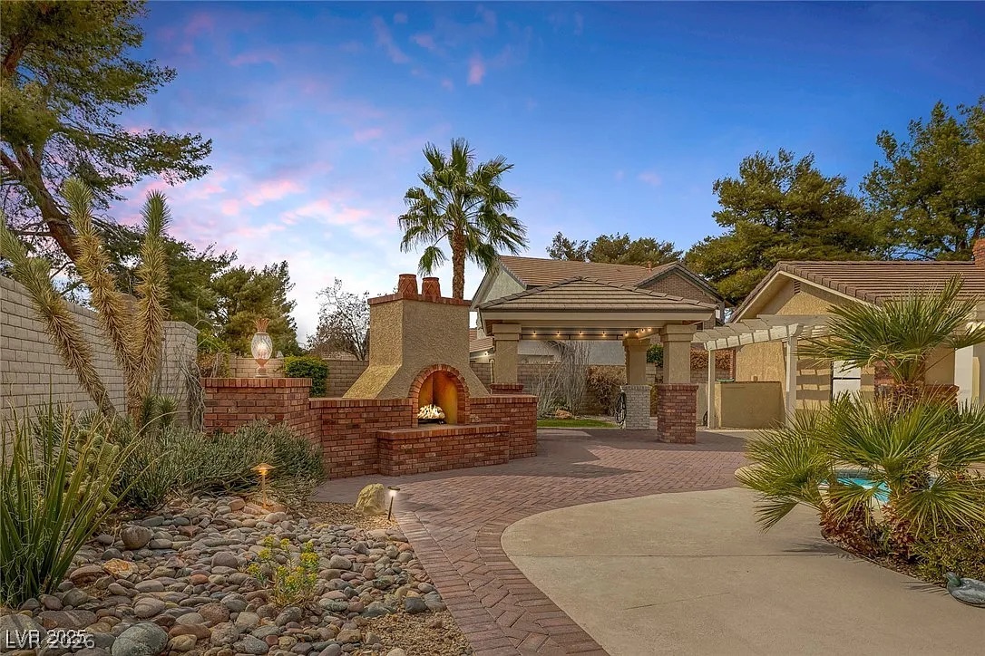 9 Quail Run Road Henderson, NV 89014 - Photo 45 of 57 An inviting outdoor fireplace provides a focal point for this property's thoughtfully landscaped exterior.