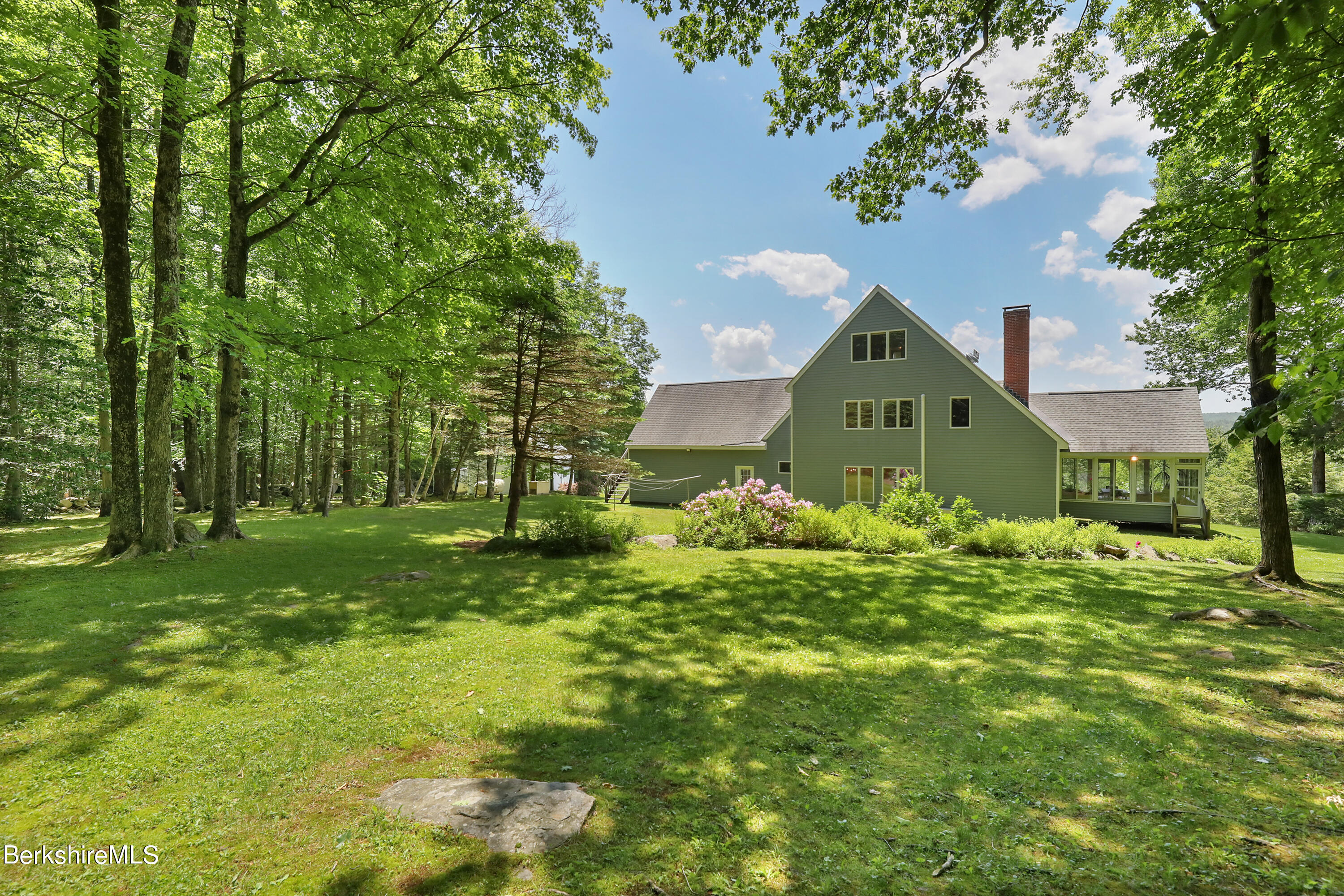 86 George Carter Road Becket, MA 01223 - Photo 1 of 35 a front view of a house with a yard