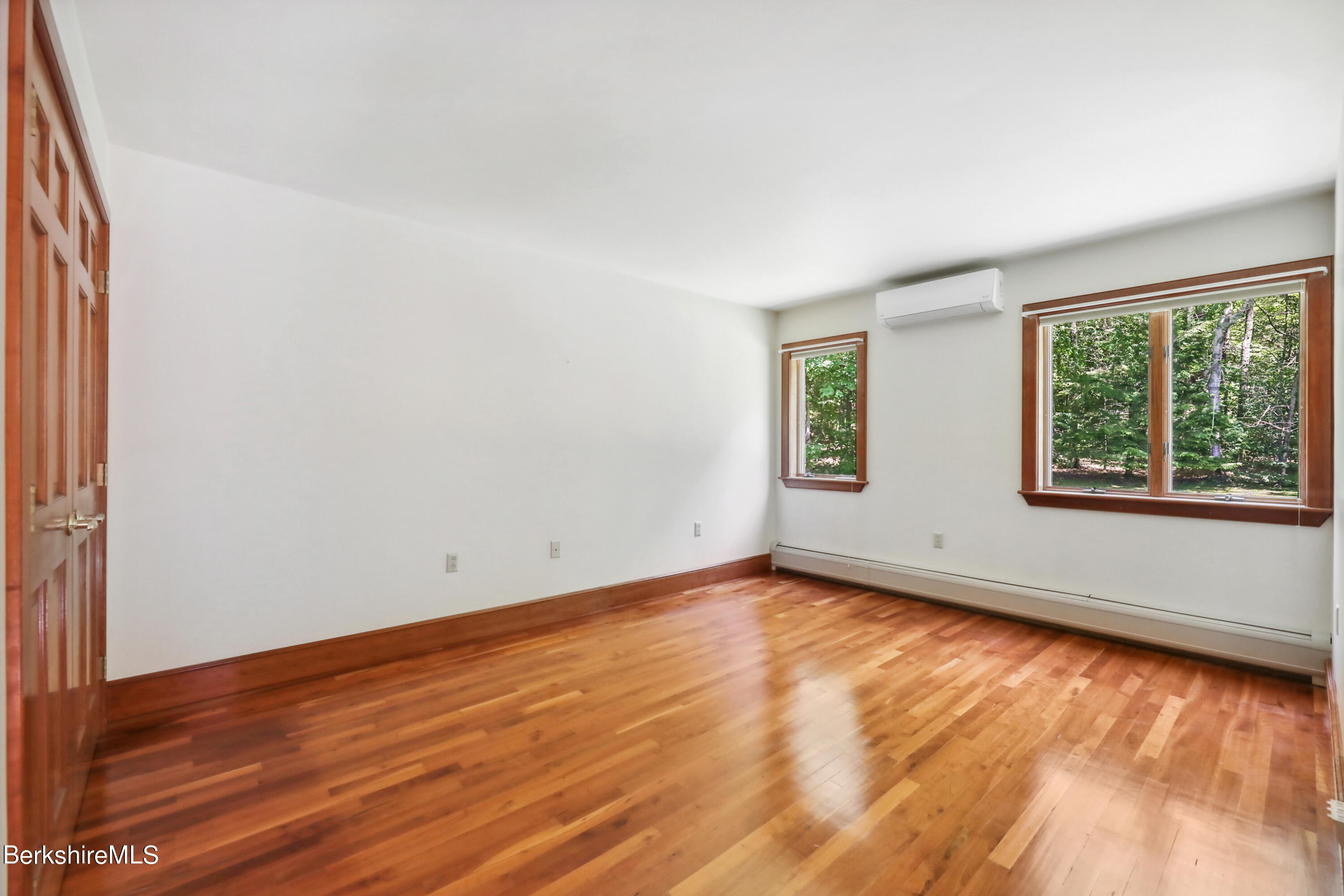 86 George Carter Road Becket, MA 01223 - Photo 20 of 35 an empty room with wooden floor and windows