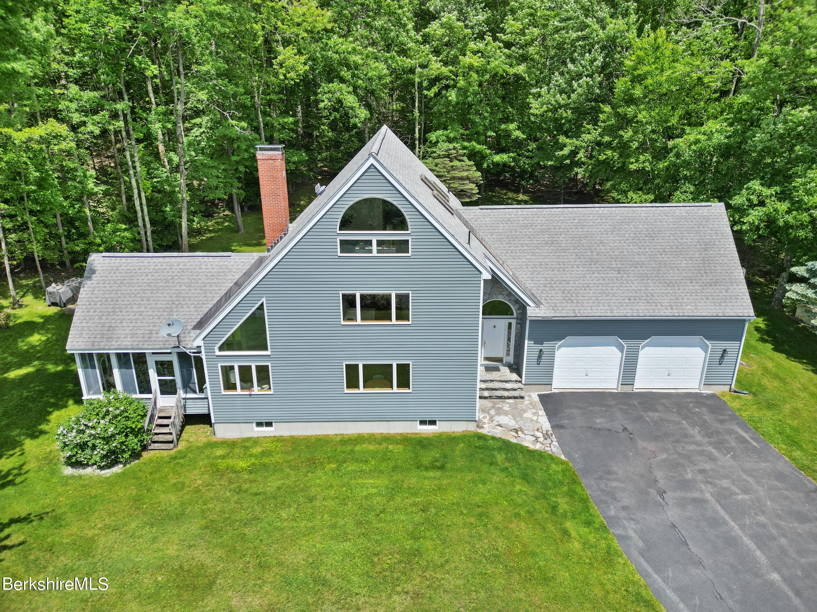 86 George Carter Road Becket, MA 01223 - Photo 3 of 35 a front view of a house with a garden