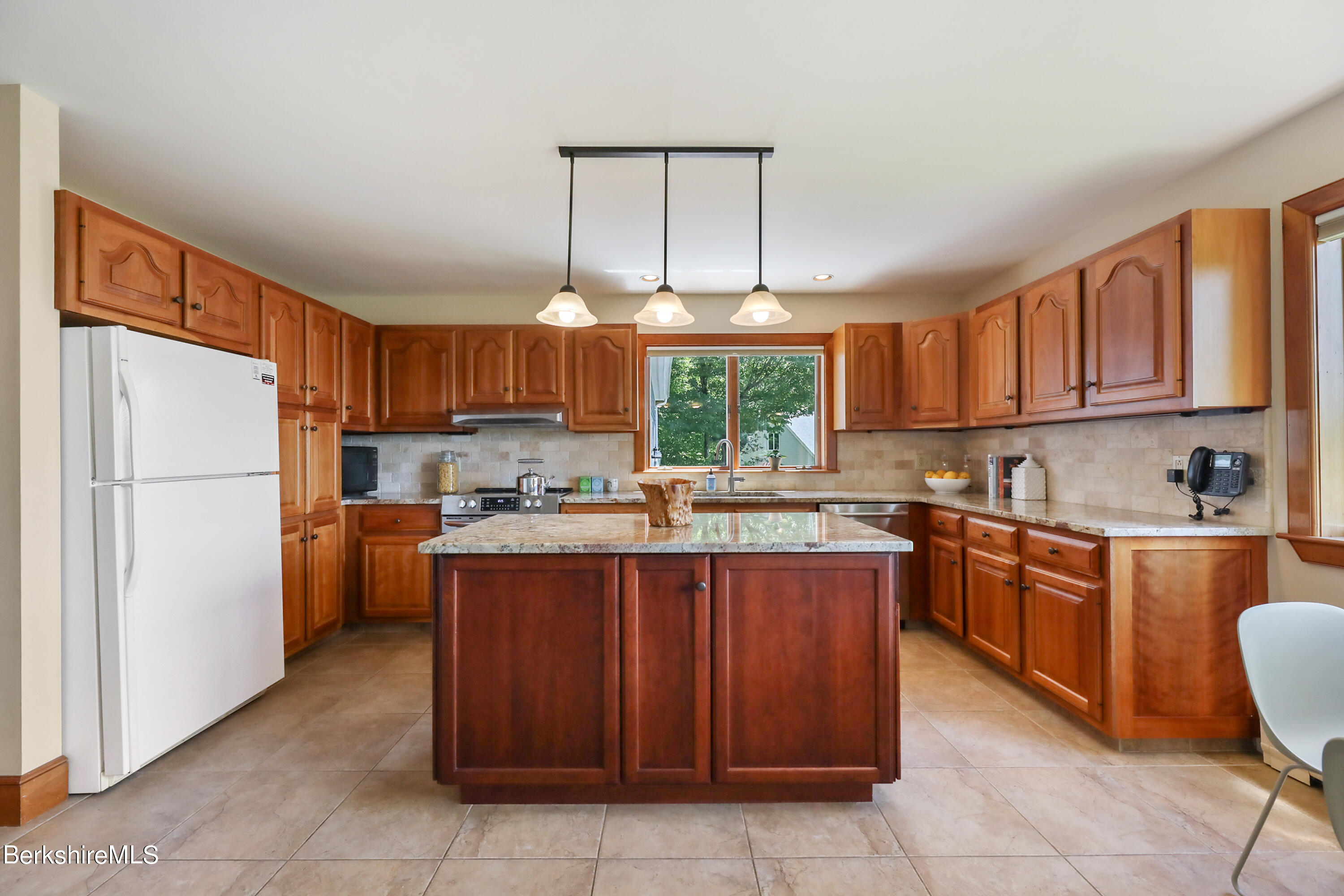 86 George Carter Road Becket, MA 01223 - Photo 5 of 35 a kitchen with stainless steel appliances granite countertop a refrigerator and a stove top oven