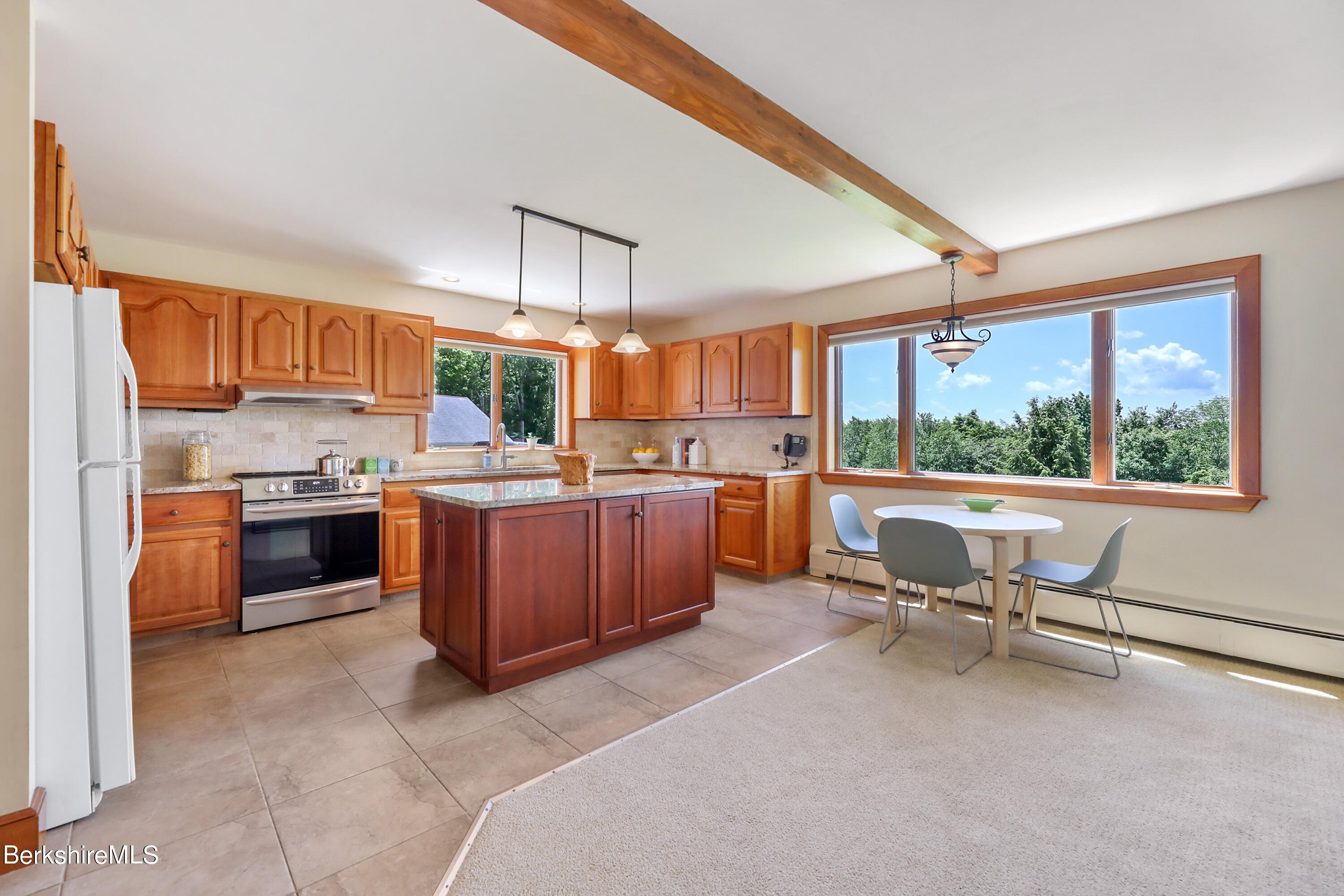 86 George Carter Road Becket, MA 01223 - Photo 6 of 35 a kitchen with a window appliances and chairs