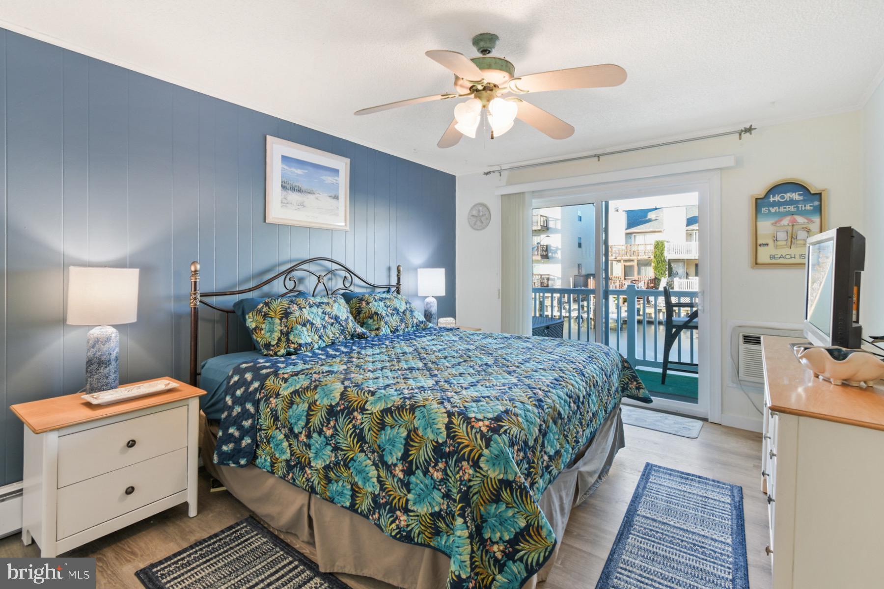 722 Mooring Road, Unit A104 Ocean City, MD 21842 - Photo 16 of 33 a bedroom with a bed and a chandelier