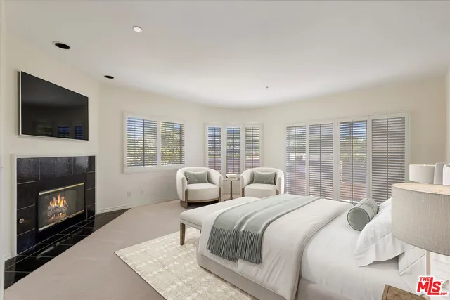 a bedroom with a balcony a bed and a television