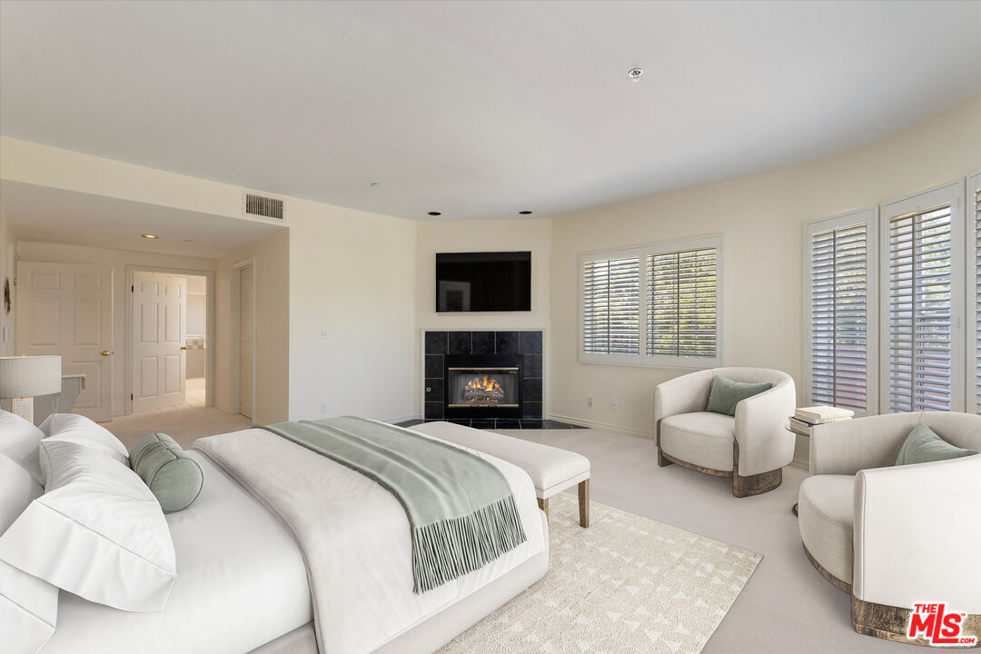 4310 Cahuenga Boulevard, Unit 304 Toluca Lake, CA 91602 - Photo 16 of 35 a spacious bedroom with a bed and a couch