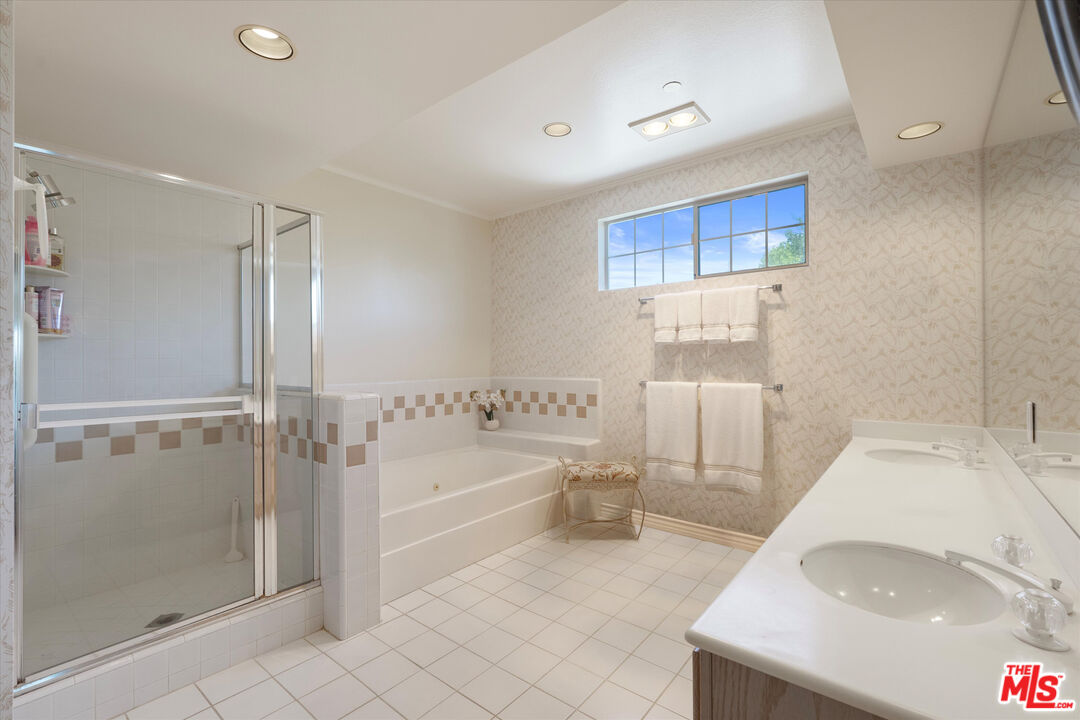 4310 Cahuenga Boulevard, Unit 304 Toluca Lake, CA 91602 - Photo 19 of 35 a spacious bathroom with a tub sink and shower