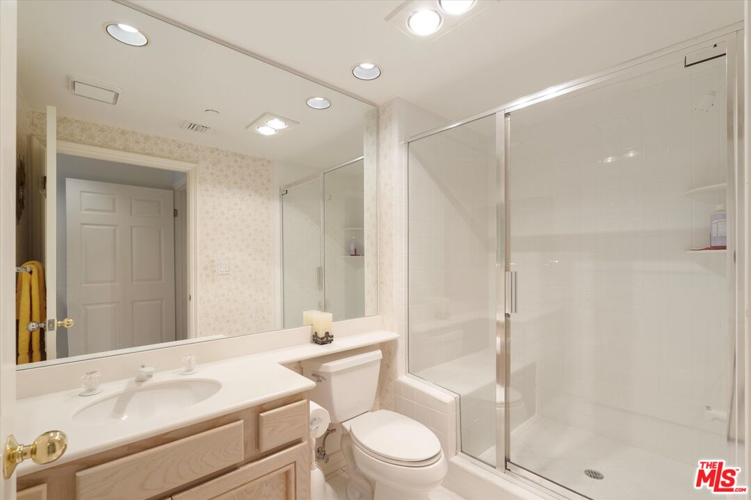 4310 Cahuenga Boulevard, Unit 304 Toluca Lake, CA 91602 - Photo 24 of 35 a bathroom with a sink a toilet and shower