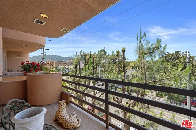 a view of a balcony with chair and potted plants