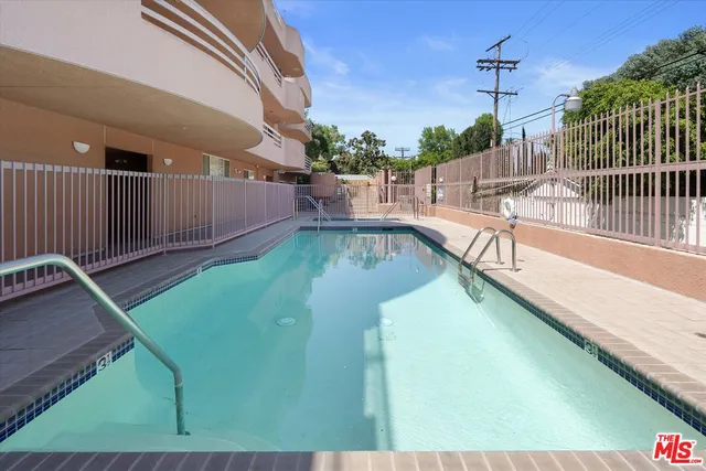 a view of a backyard with swimming pool