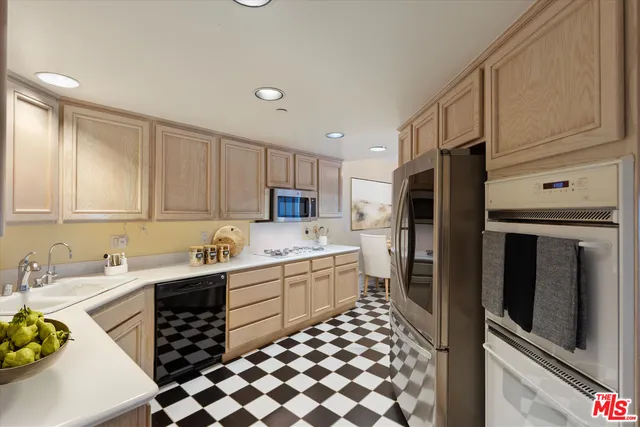 a kitchen with a sink a stove and refrigerator