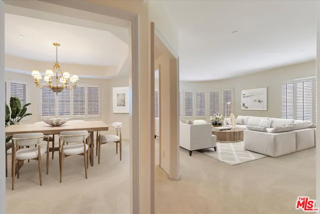 a view of a dining room with furniture and chandelier