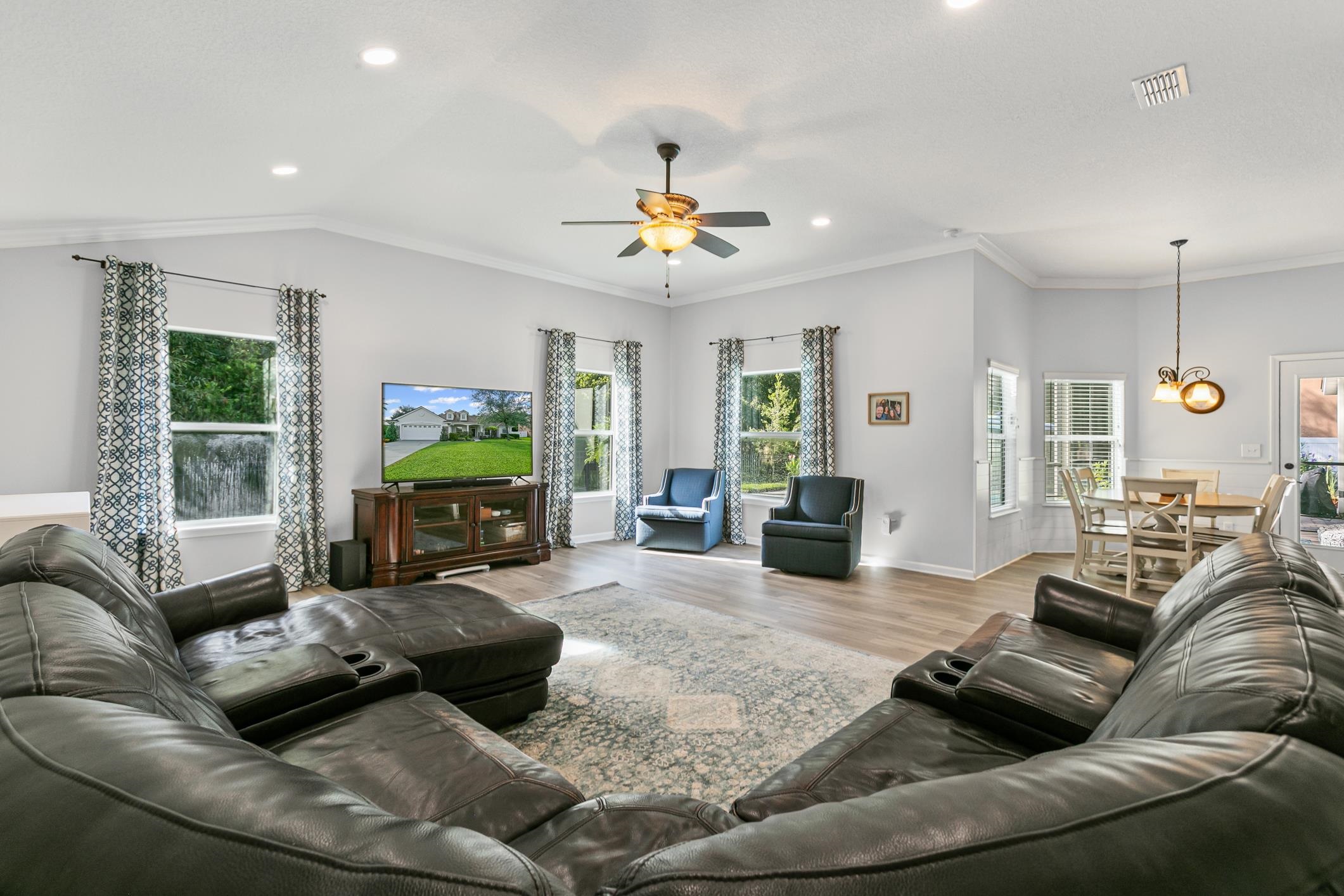 2724 North Portofino Road St. Augustine, FL 32092 - Photo 33 of 86 Living area with wood finished floors, plenty of natural light, ornamental molding, ceiling fan, and recessed lighting