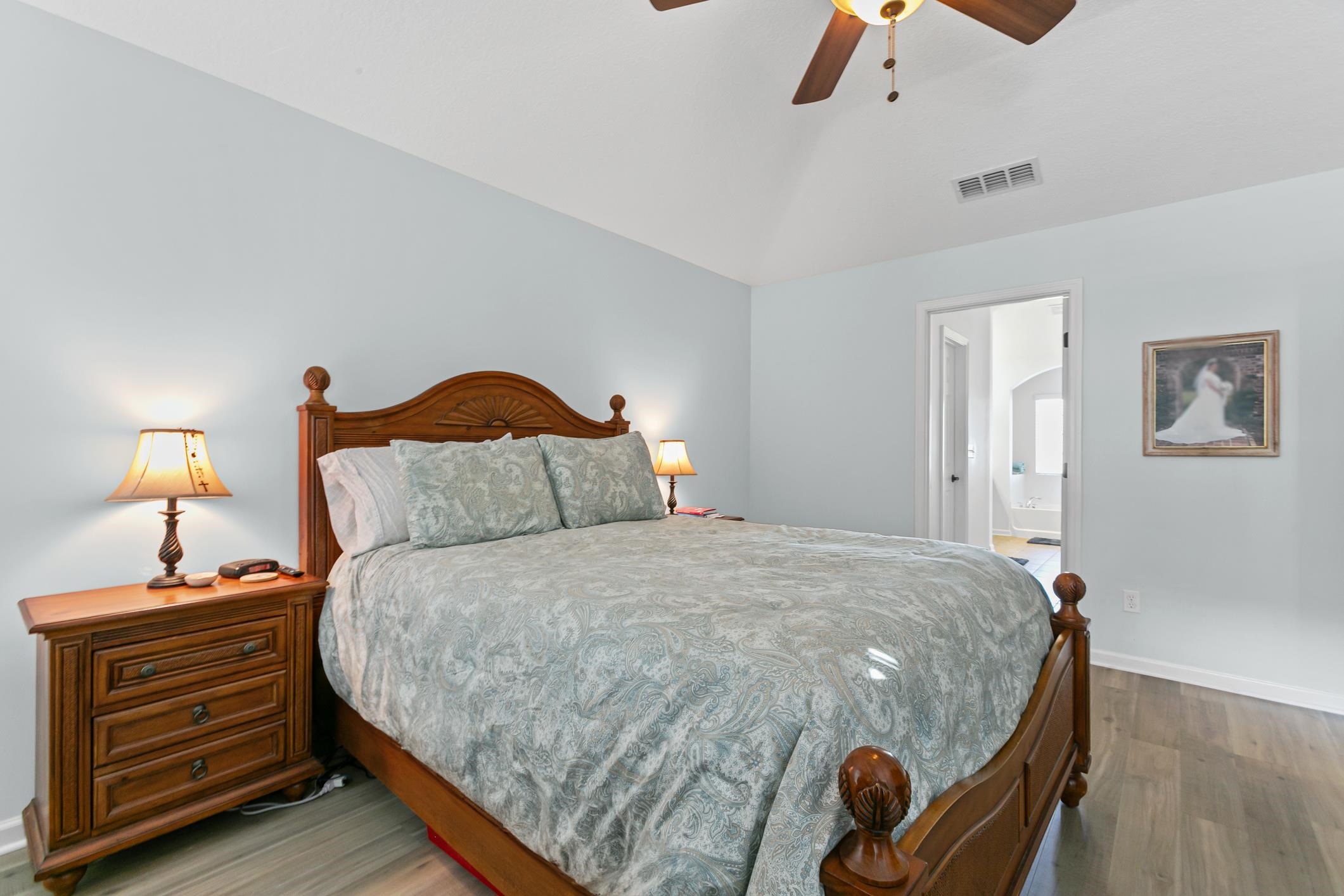 2724 North Portofino Road St. Augustine, FL 32092 - Photo 36 of 86 Bedroom featuring wood finished floors, ceiling fan, vaulted ceiling, and ensuite bathroom
