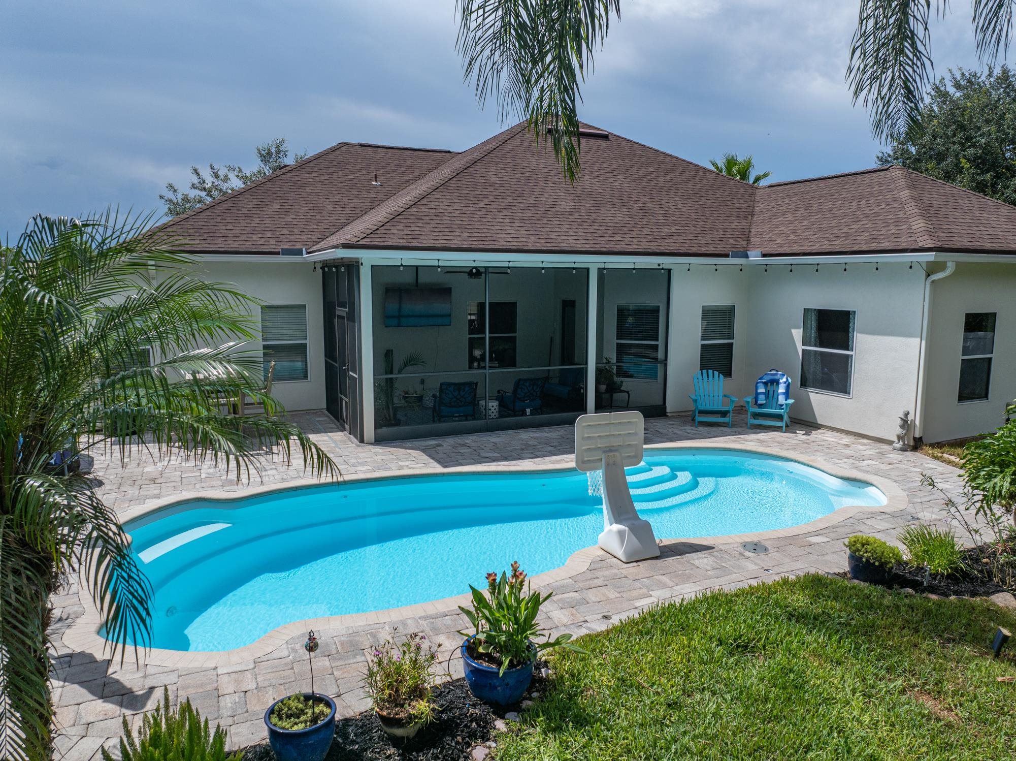 2724 North Portofino Road St. Augustine, FL 32092 - Photo 57 of 86 Outdoor pool featuring a patio area and a sunroom