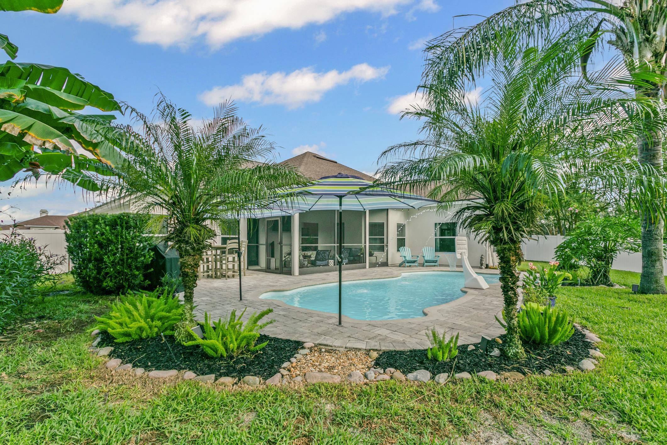 2724 North Portofino Road St. Augustine, FL 32092 - Photo 61 of 86 Rear view of property featuring an outdoor pool, a patio, stucco siding, and a yard