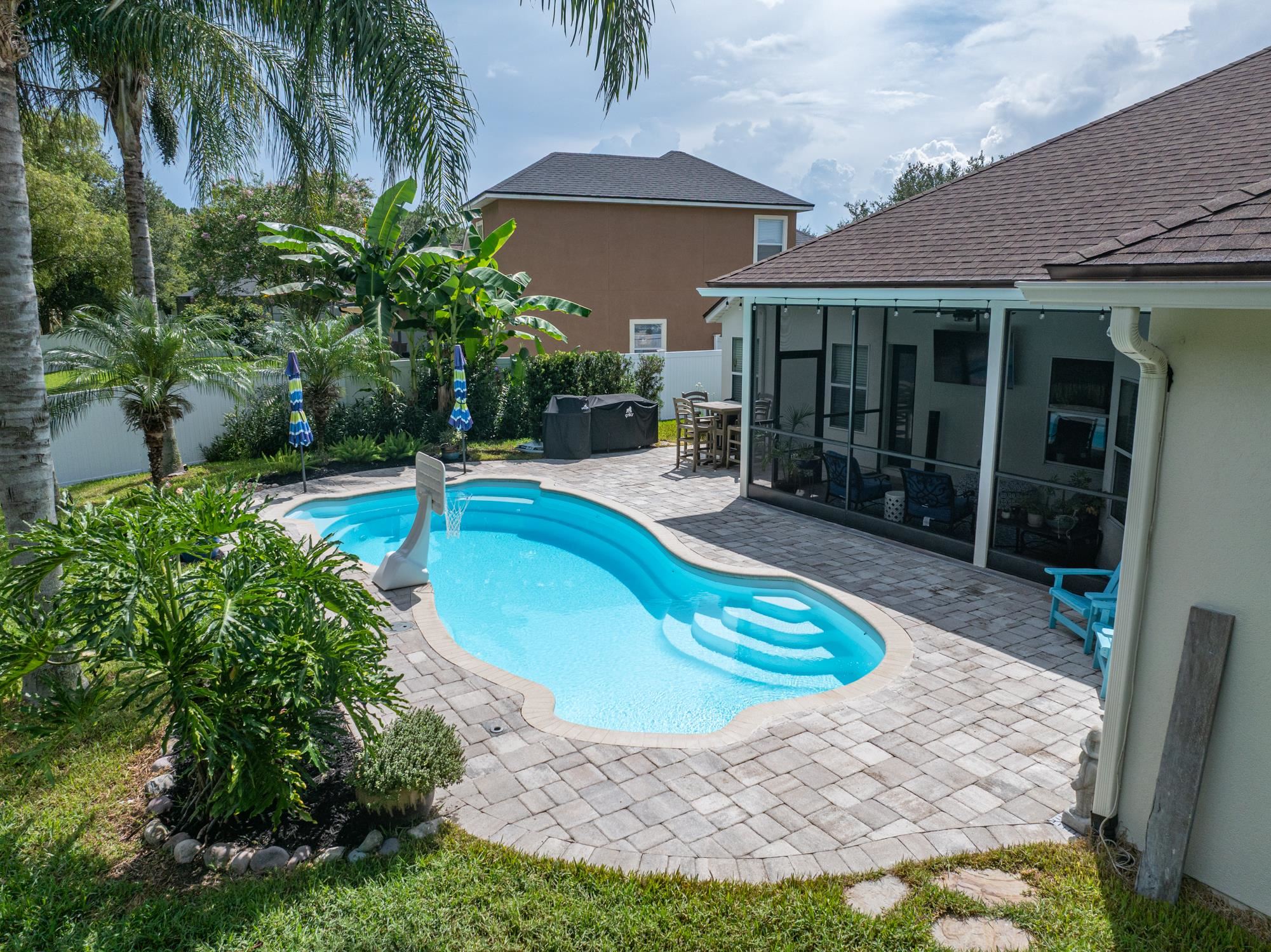 2724 North Portofino Road St. Augustine, FL 32092 - Photo 63 of 86 View of swimming pool featuring a patio, a sunroom, and a fenced backyard