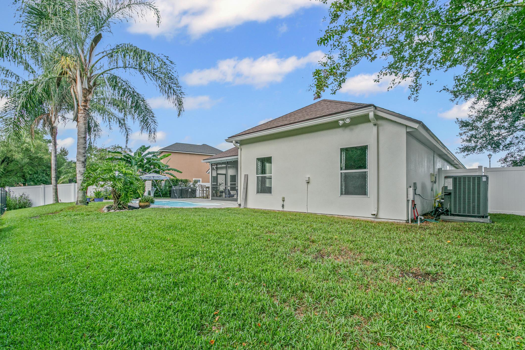 2724 North Portofino Road St. Augustine, FL 32092 - Photo 67 of 86 Back of property with a fenced backyard, a patio, and stucco siding