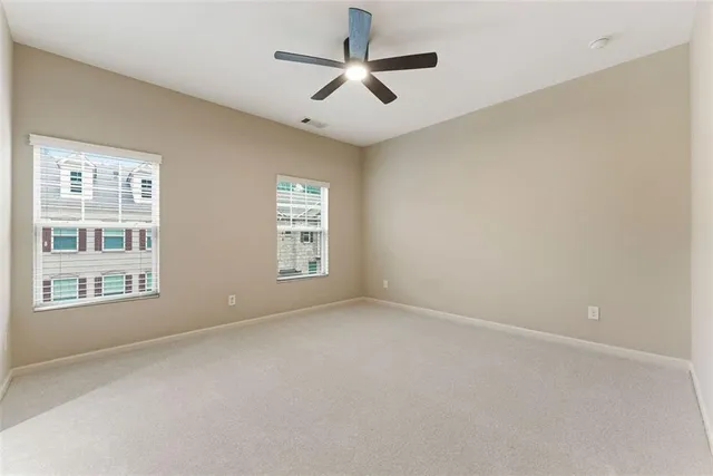an empty room with closet and fan