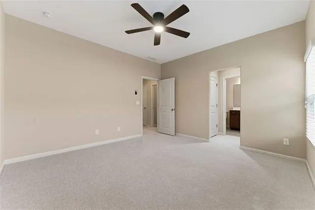 a bedroom with a bed and painting on the wall