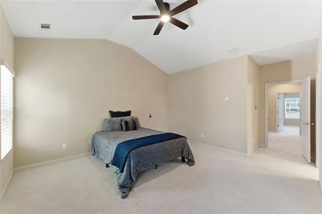 a bedroom with a bed and a large window