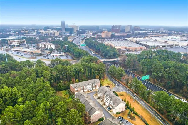 an aerial view of residential houses with yard and ocean view