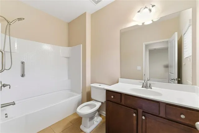 a spacious bathroom with a shower sink and mirror