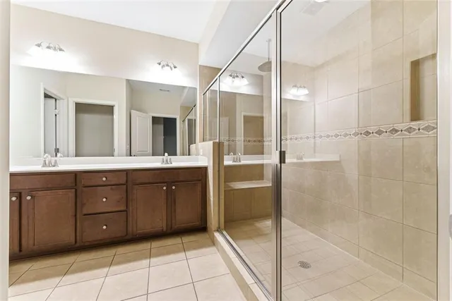a bathroom with a shower sink and mirror
