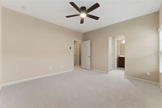 a bathroom with a sink a toilet a mirror and shower