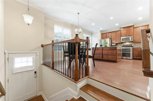 a view of a kitchen with dining room and wooden floor