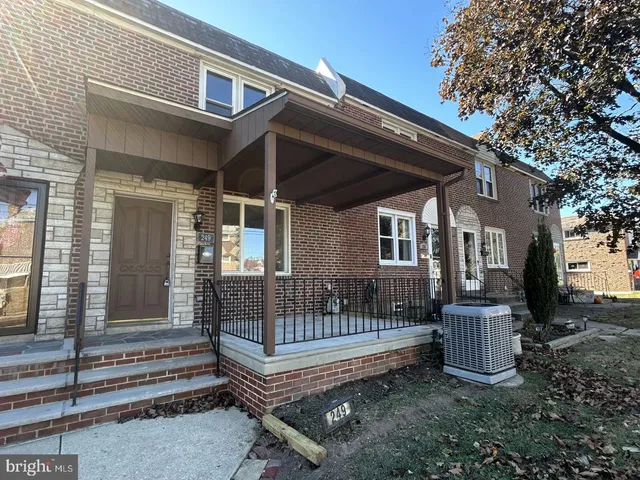 a view of a house with a small yard and wooden fence