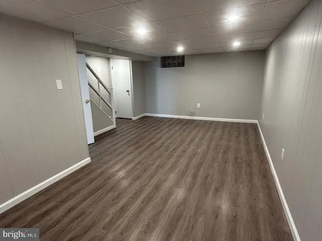 an empty room with wooden floor