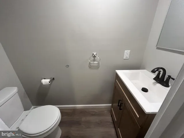 a white toilet sitting next to a bathroom sink