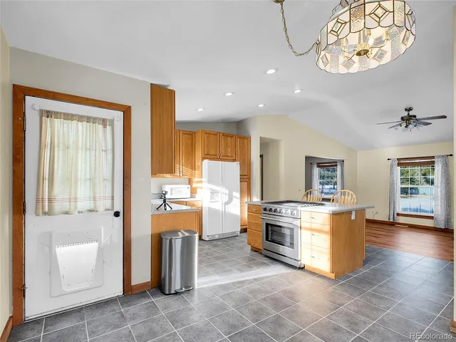 a kitchen with stainless steel appliances granite countertop a stove and a refrigerator