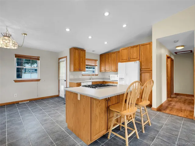 a kitchen that has a table and chairs in it