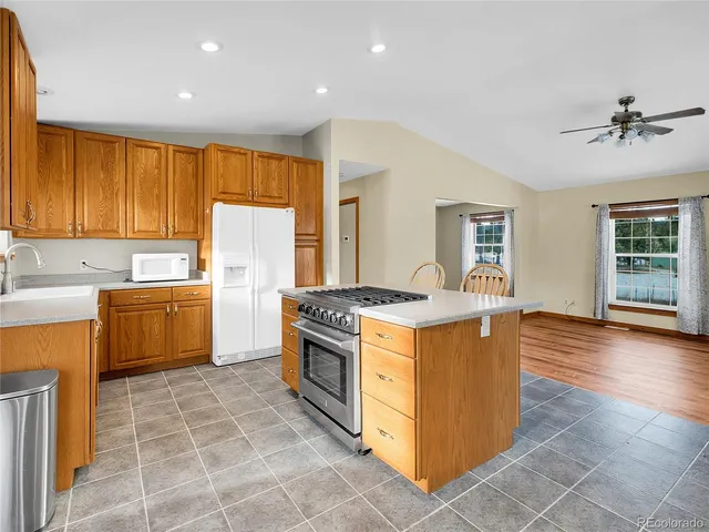 a kitchen with a stove a sink and a refrigerator