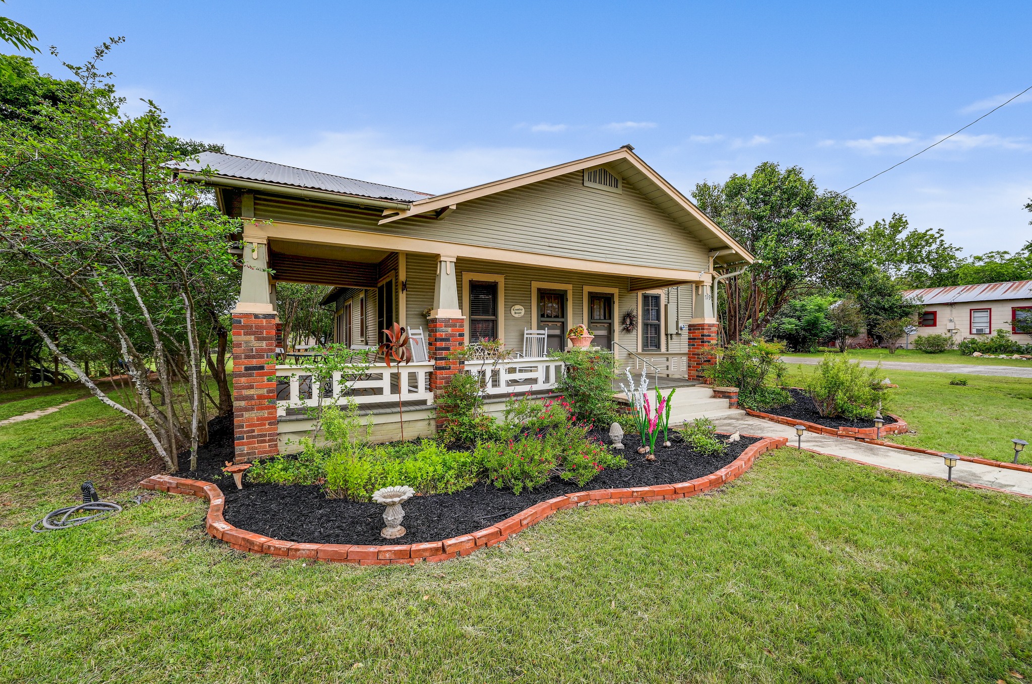 719 Elm Street Blanco, TX 78606 - Photo 1 of 25 Single-story residence featuring light green siding and a covered front porch