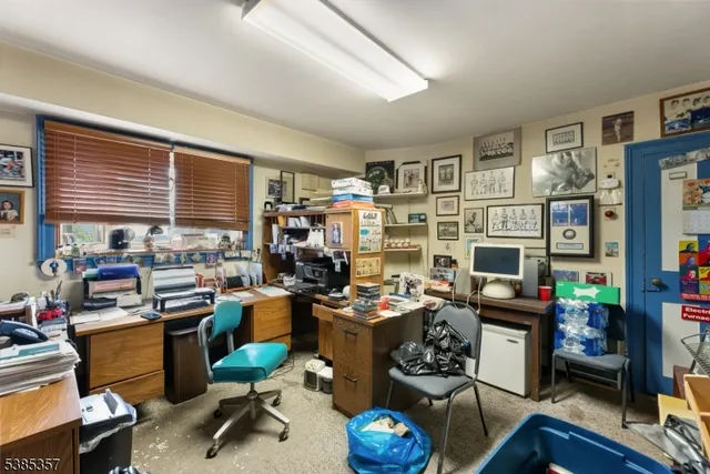 a view of a workspace with furniture and a kitchen