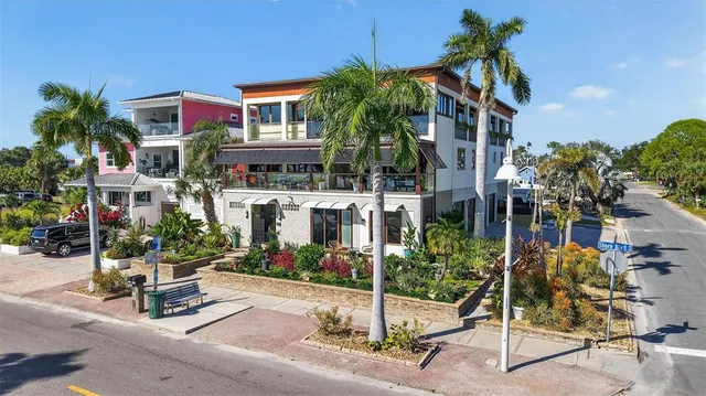 a front view of a building with a garden