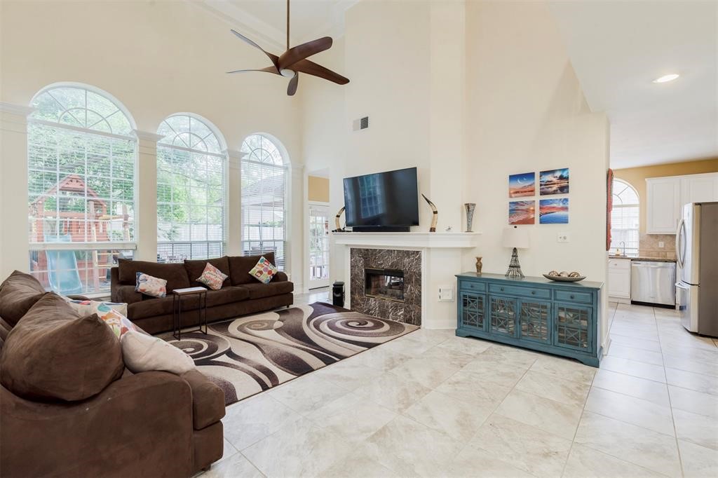14103 Heatherhill Place Houston, TX 77077 - Photo 19 of 47 a living room with furniture a fireplace and a large window
